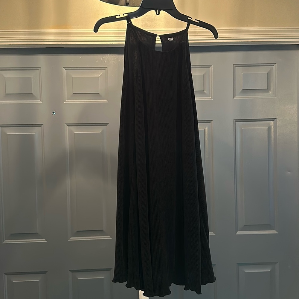 Black dress. Unknown material but very luxurious and free flowing as you walk.